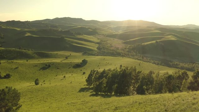 Aerial Drone Footage View: Flight over autumn mountain village with forests, fields and river in sunrise soft light. Majestic landscape. Beauty world. 4K. Beautiful view.