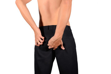 Men wearing black pants not wear a coat and scratch the buttocks caused by acute parasites or acute...