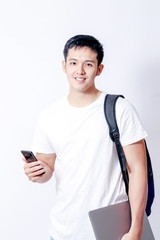 A Portrait of young asian man in white shirt and blue jeans  showing gesture sign or devices