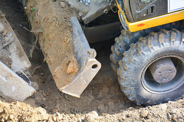 Close-up of construction equipment. Soil extraction by excavator. Improvement and construction, road works. Works on landscaping the park area.