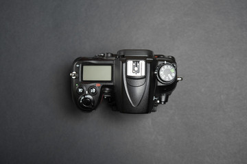 Digital Single Lens Reflex on black background without lens, body view from above on black background - obrazy, fototapety, plakaty