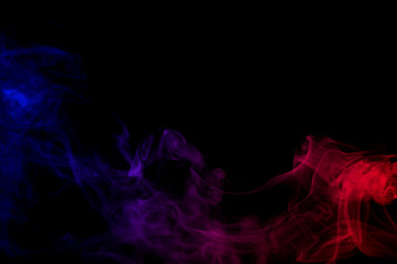 abstract gradient red and blue color smoke as wave line in the dark air on black background 
