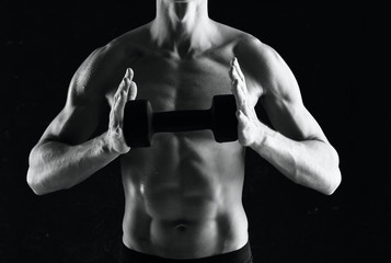 Fototapeta na wymiar bodybuilder posing on black background