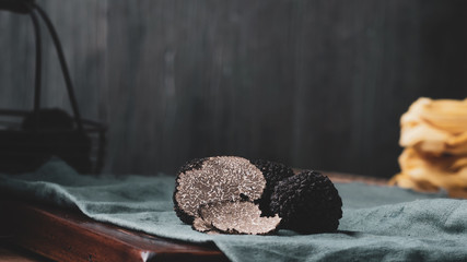 Black truffles mushrooms on rustic wooden table - obrazy, fototapety, plakaty