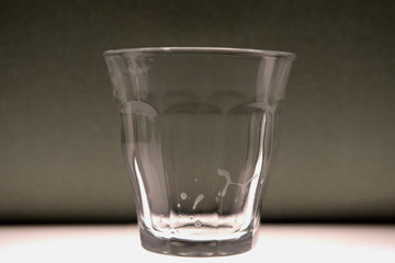 Recently emptied glass with residue of liquid on the sidess.