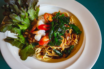 Spaghetti with chili seafood and hot basil leaves