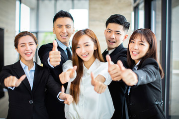 confident asian business team showing thumbs up
