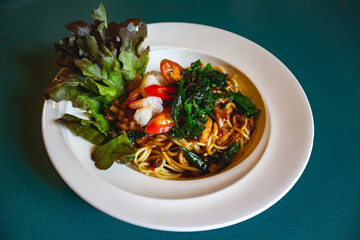 Spaghetti with chili seafood and hot basil leaves