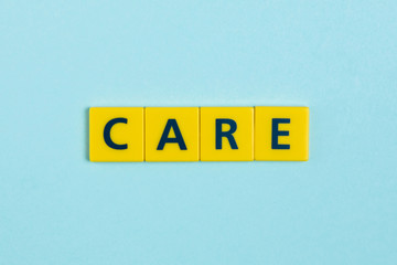 Care word on scrabble tiles