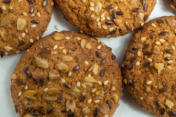 Macro photo of brown dietary low-calorie fitness cereal biscuits with sprinkling closeup on white background.