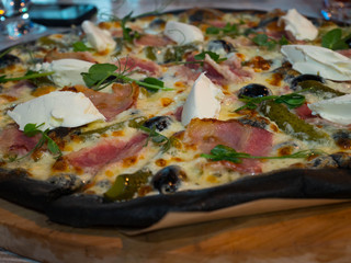 whole pizza on a wooden tray