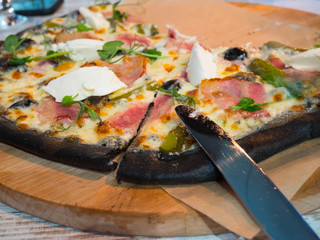 not full pizza on a wooden tray