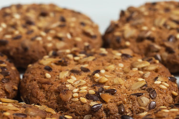 Macro photo of brown dietary low-calorie fitness cereal biscuits with sprinkling closeup on white background.