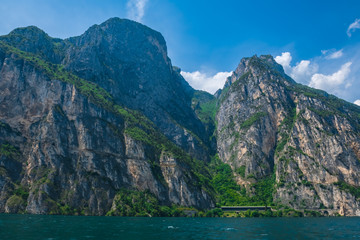 View of Lake Garda and mountains on a cloudy day.