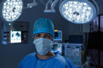 Fototapeta na wymiar Female surgeon standing in the operation room of hospital