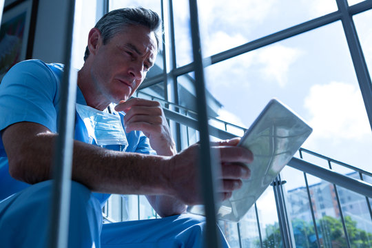 Male doctor using digital tablet in the hospital - Powered by Adobe