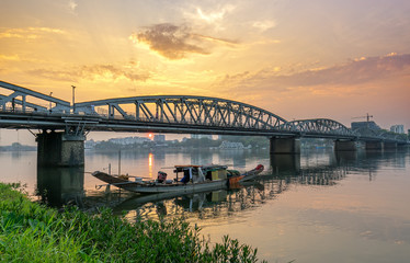 Fototapeta na wymiar Dawn at Trang Tien Bridge. This is a Gothic architectural bridge spanning the Perfume river from the 18th century designed by Gustave Eiffel in Hue, Vietnam