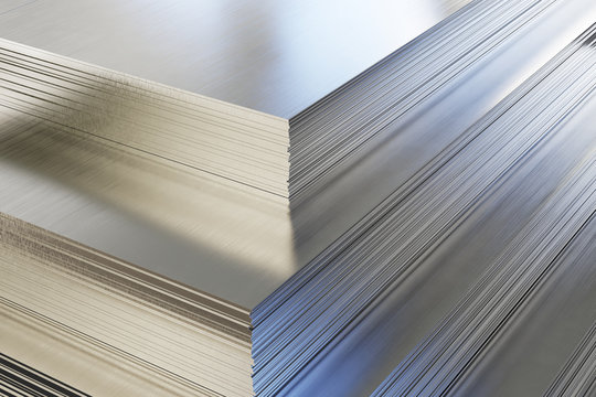 Steel or aluminum sheets in warehouse, rolled metal product.