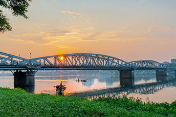 Dawn at Trang Tien Bridge. This is a Gothic architectural bridge spanning the Perfume river from the 18th century designed by Gustave Eiffel in Hue, Vietnam