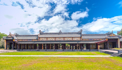 Long feudal house with wooden architecture, colorful roof tiles decoration where mandarins,...