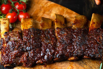 BBQ beef ribs steak served with a hot chili pepper and fresh tomatoes top down view