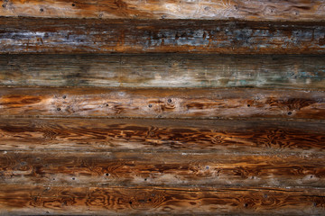 Wooden background. Log cabin wall background. Old weathered orange logs.