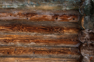 Log cabin wall background. Old weathered orange logs. Wooden background.