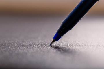 automatic blue plastic ballpoint pen with clipping path on black background. close up.
