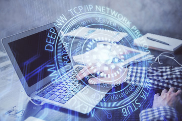 Businessman with computer background with technology theme hologram. Concept of hightech. Multi exposure.