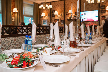 The banquet table in the restaurant is fully reserved and snacks are on display.