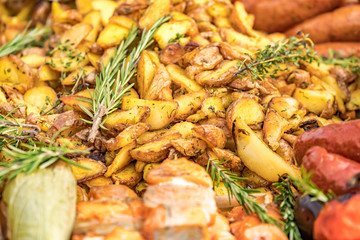 Fried potatoes with fried sausages in a pan. Dish fried potatoes with sausages, onions, garlic, cumin, pepper and seasonings.