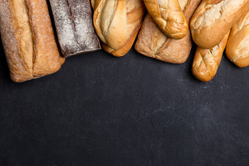 Assortment of fresh bread on dark background