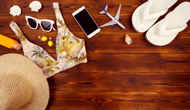 Vacation travel equipment Straw hat, sunglasses And marine objects, shells, on wooden floor - Image