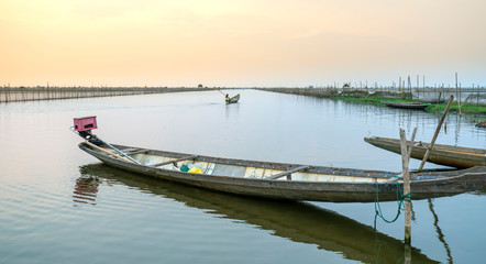 Fototapeta na wymiar Wooden boat dock in Chuon lagoon, Hue, Vietnam. This is a living means of transportation in the flooded area in central Vietnam