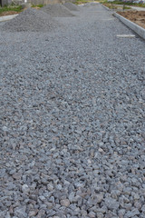 Road construction.Gray gravel and curb
