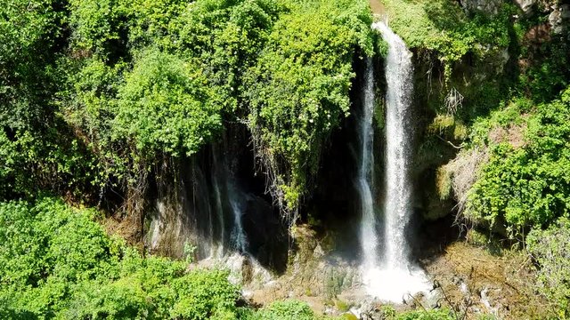 Magnificent waterfall in Sunny weather in Tivoli wildlife Park, Italy.