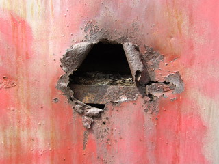 Break in old metal sheet. Hole in old iron construction. 