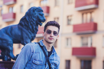 Fototapeta premium positive handsome man with glasses walking around the city
