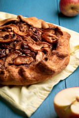 Home-baked apple pie on kitchen towel. Crispy crust and pecan nuts