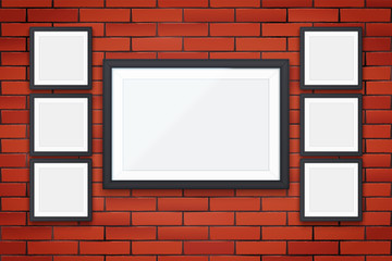 Red brick wall with picture frames