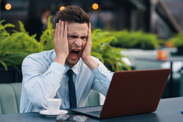 businessman working on his laptop in park