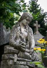 Marble statue and an ancient abandoned Gothic cemetery