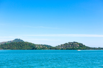 Fototapeta na wymiar View of a green island in the blue ocean