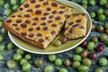 sliced ​​homemade pie with gooseberries on plate