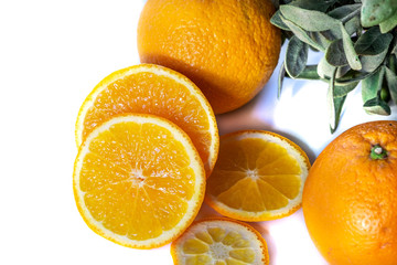 Sliced orange with green leaf isolated on white background