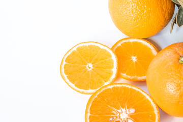 Sliced orange with green leaf isolated on white background