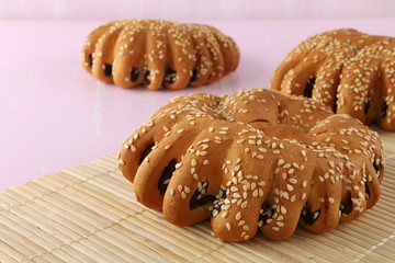Bakery - gold rustic crusty loaves of bread and buns on textured background.