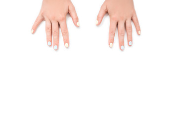 Fresh blue and yellow manicure on white isolated background