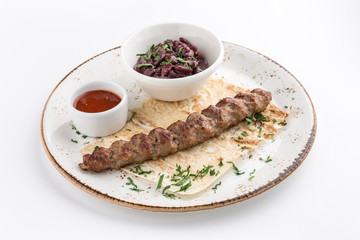 cooked lamb shish kofta kofte kebab with beans and pita isolated on white background