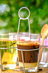 a glass of black coffee with condensed milk in retro style coffee shop